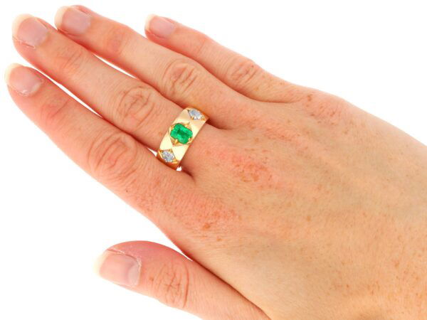 antique emerald and diamond gold band on hand