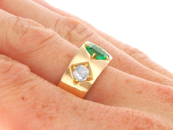 antique emerald and diamond gold band on finger