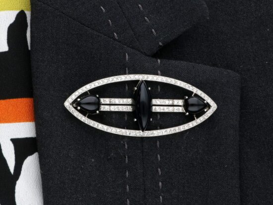 wearing Navette Onyx and Diamond Brooch with Diamonds