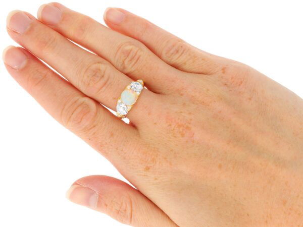 opal and diamond trilogy ring pn hand