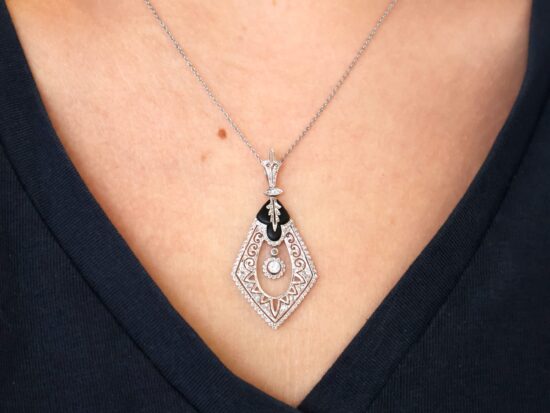 wearing Black Onyx and Diamond Pendant in Platinum