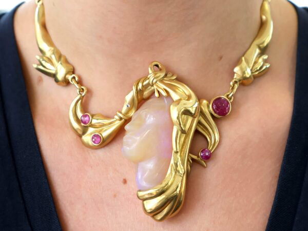 gold carved opal and ruby necklace on neck