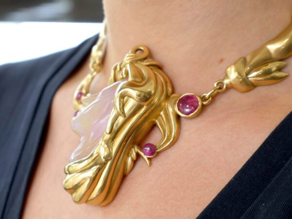 18ct yellow gold carved opal and ruby necklace on the neck