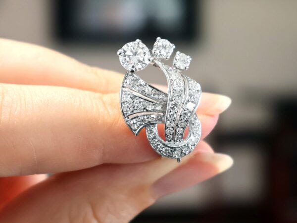 holding vintage art deco diamond earring