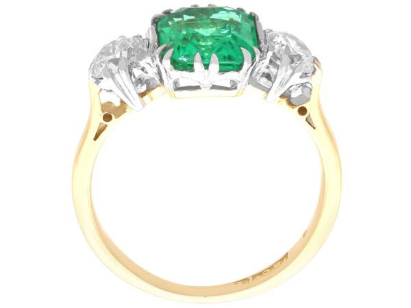 side view emerald trilogy engagement ring in yellow gold