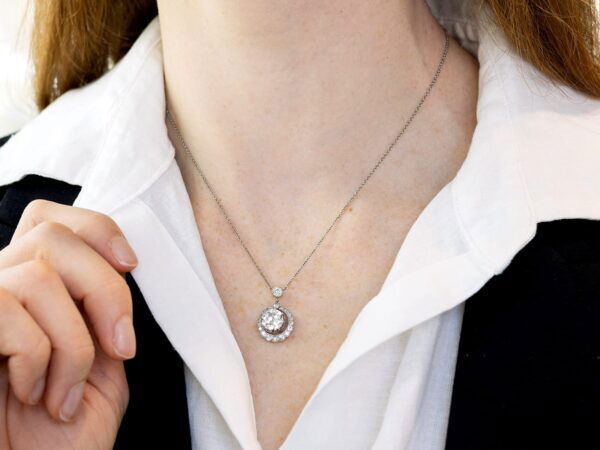 wearing halo diamond pendant necklace in platinum