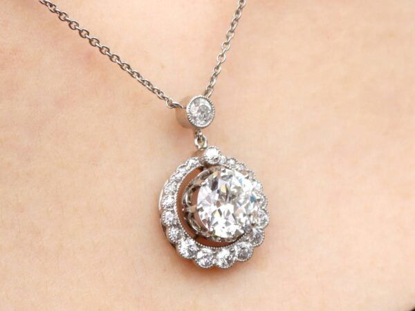 wearing a halo diamond pendant necklace