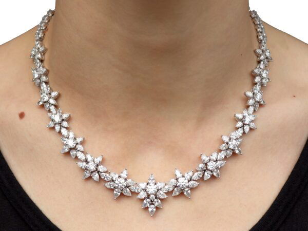 White gold floral diamond necklace on neck