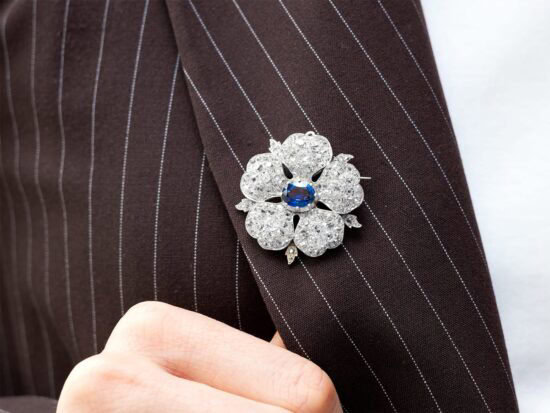 wearing sapphire and diamond flower brooch