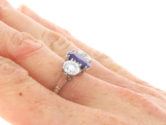 Cushion Cut Sapphire Trilogy Ring On Hand