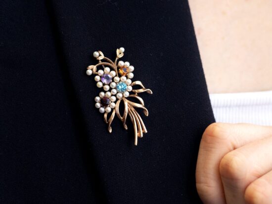 wearing gold gemstone brooch
