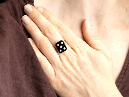 wearing an onyx and diamond dice ring