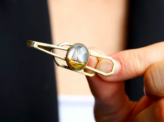 holding a crystal tie pin