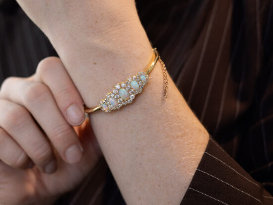 Victorian opal and diamond yellow gold bangle wearing