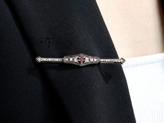 wearing an onyx and ruby brooch