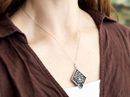 wearing an onyx and diamond pendant