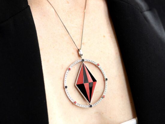 wearing a coral and onyx pendant