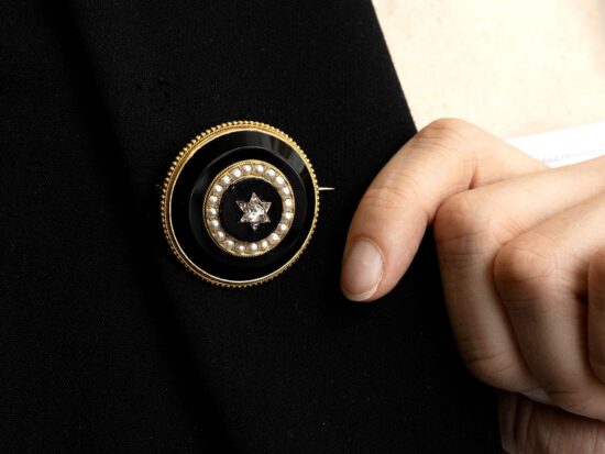 wearing round onyx brooch