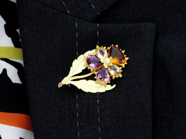 wearing gold flower brooch gemstone
