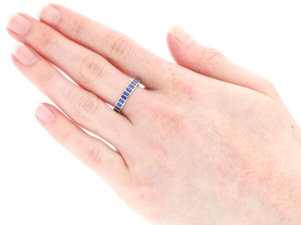 wearing a white gold sapphire eternity ring