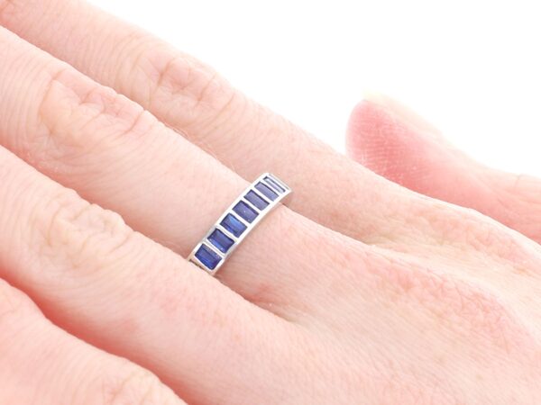 white gold sapphire eternity ring on finger