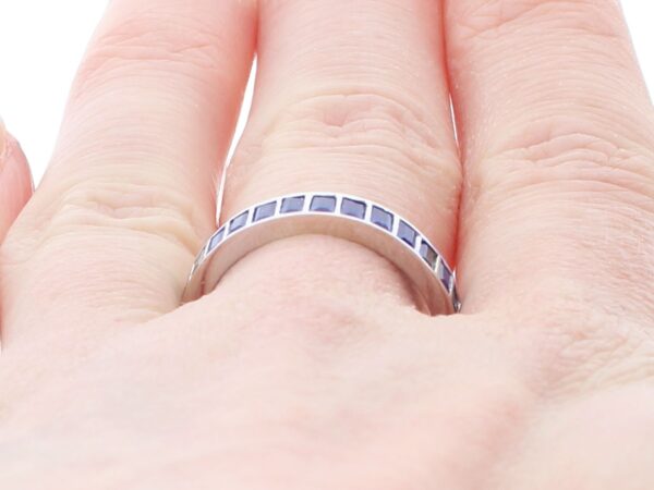 white gold sapphire eternity ring on hand
