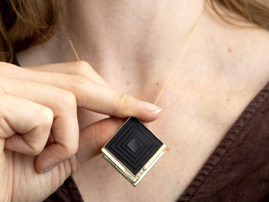 wearing onyx pendant in gold