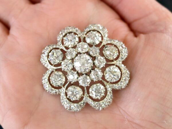 holding a Victorian diamond brooch