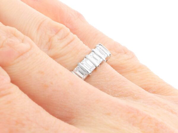 emerald cut diamond eternity ring on finger
