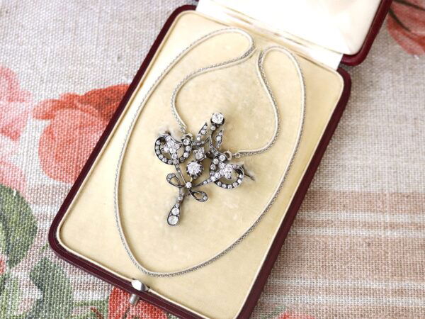Edwardian diamond pendant brooch in gold with box open