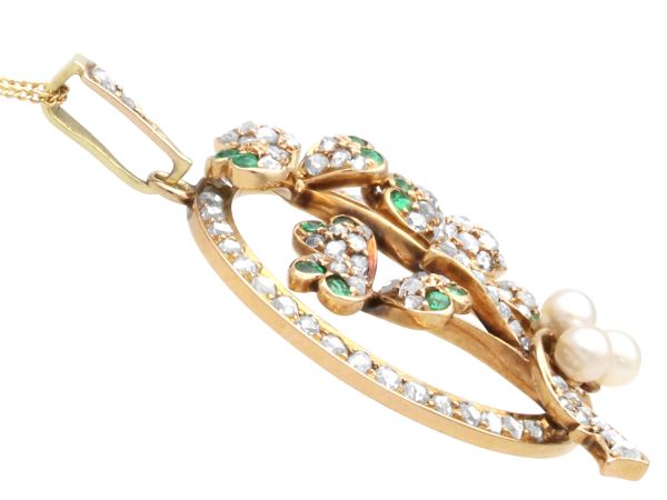 circular gold pendant with pearls and emeralds side view