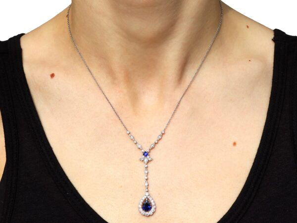 wearing pear shaped sapphire and diamond pendant