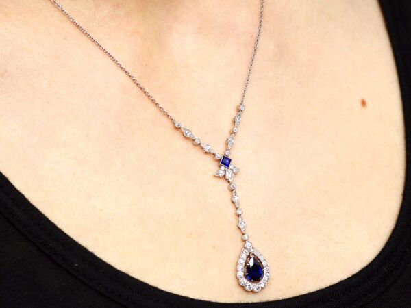 pear shaped sapphire and diamond pendant on neck